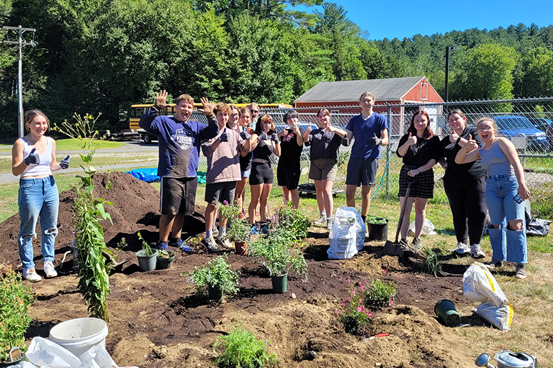 MTRS students planting plants in the pollinator garden