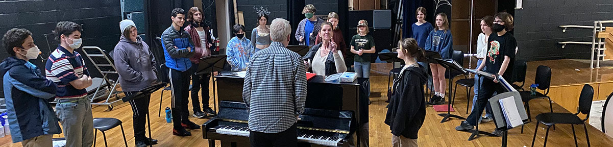 Class practicing together for the musical around the piano