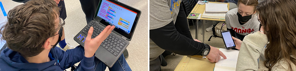 Student working on a laptop and teacher helping two girls in the classroom