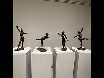 Four small black sculptures at the Clark Art Museum