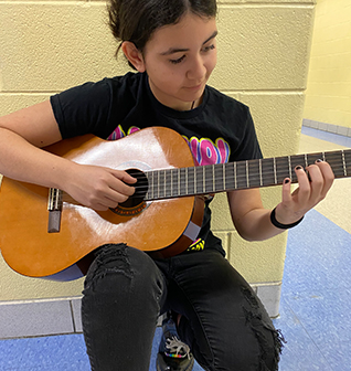 Girl playing the guitar